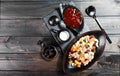 Muesli bowl with yogurt, granola, sliced banana, cashew, almonds, cranberries, nuts, dried fruits mix on dark wooden table Royalty Free Stock Photo