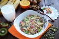 Muesli with candied fruits and nuts with a glass of milk on a dark wooden table Royalty Free Stock Photo