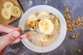 Muesli with chocolate and fresh banana on a dark gray marble table. Royalty Free Stock Photo