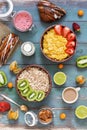 Muesli, corn flakes, strawberries, kiwi, milk, nuts, physalis, coffee, pastries. Colorful varied breakfast on a green-blue wooden Royalty Free Stock Photo