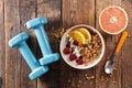 Muesli, dairy and fruit- dumbbell- fitness food concept