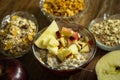 Muesli with dried fruit, milk and sliced red apple on wooden table Royalty Free Stock Photo