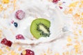 Muesli and fresh berries and fruits with splashing milk Royalty Free Stock Photo