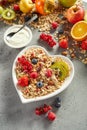 Muesli with fruits and yogurt on table