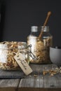 Organic homemade granola cereal with oats, nuts and dried berries. Muesli in a glass jar on the dark backround. Healthy vegan Royalty Free Stock Photo