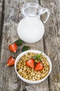 Muesli and a jug of milk for breakfast. Granola with strawberry Royalty Free Stock Photo