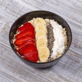 Muesli made from red strawberries, banana, chia seeds, oat flakes, honey and dressed with yogurt Royalty Free Stock Photo