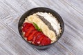 Muesli made from red strawberries, banana, chia seeds, oat flakes, honey and dressed with yogurt, close up Royalty Free Stock Photo