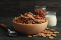 Muesli, milk, almond and spoon on wooden table Royalty Free Stock Photo