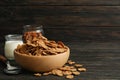 Muesli, milk, almond and spoon on wooden table Royalty Free Stock Photo