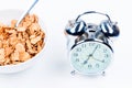 muesli in a plate and an alarm clock on a table Royalty Free Stock Photo