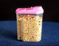 Muesli in transparent kitchen container closeup Royalty Free Stock Photo