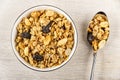 Muesli in glass bowl, granola in spoon on wooden table. Top view Royalty Free Stock Photo