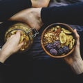 Muesli in wooden bowl with cranberries and nuts in hands Royalty Free Stock Photo