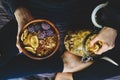 Muesli in wooden bowl with cranberries and nuts in hands Royalty Free Stock Photo
