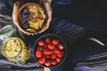 Muesli in wooden bowl with cranberries and nuts in hands Royalty Free Stock Photo