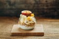 Muesli with yoghurt and tropical fruit at brown background Royalty Free Stock Photo