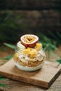 Muesli with yoghurt and tropical fruit at brown background Royalty Free Stock Photo