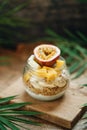 Muesli with yoghurt and tropical fruit at brown background Royalty Free Stock Photo