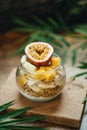 Muesli with yoghurt and tropical fruit at brown background Royalty Free Stock Photo