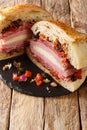 Muffaletta Sandwich with Homemade Bread and Olive Salad close-up on the table. Vertical Royalty Free Stock Photo