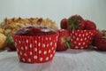 Muffin and fresh strawberries, croissants , cake with almonds