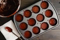 Muffin Pan Filled with Chocolate Cupcake Batter in Paper Cups Royalty Free Stock Photo