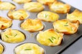 A muffin pan filled with vegetable and bacon omelette cups Royalty Free Stock Photo