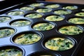A muffin pan packed with healthy vegetable omelette for brunch Royalty Free Stock Photo