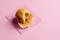 Muffin partially eaten on pink background. One muffin with missing bite Royalty Free Stock Photo