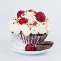 Muffin with whipped cream, cherries and crumbs