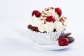 Muffin with whipped cream, cherries and crumbs