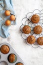 Muffins on a black cooling rack with eggs in a basket and a baking tray with muffins Royalty Free Stock Photo