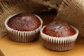 Muffins on brown jute background , cup cakes