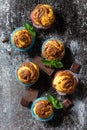 Muffins with chocolate and mint on the background of dark slate. Royalty Free Stock Photo