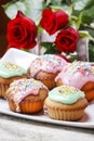 Muffins covered with pink icing and colorful sprinkles Royalty Free Stock Photo