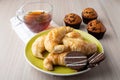 Muffins, cup of tea, croissants and caramel cookies Royalty Free Stock Photo