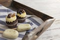 Muffins and cupcakes on tray. Cookie ice creams on a stick. Wooden background Royalty Free Stock Photo