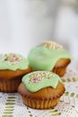 Muffins with green icing and colorful sprinkles Royalty Free Stock Photo