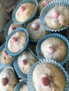 Muffins in icing sugar blue wrappers and pink top. Royalty Free Stock Photo