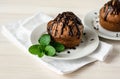 Muffins and mint on wooden background