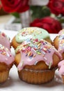 Muffins with pink icing and colorful sprinkles Royalty Free Stock Photo