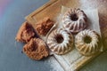 Muffins sprinkled with powdered sugar on a wooden background. Homemade cake.