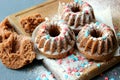 Muffins sprinkled with powdered sugar on a wooden background. Homemade cake.