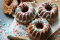 Muffins sprinkled with powdered sugar on a wooden background. Homemade cake.