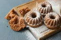 Muffins sprinkled with powdered sugar on a wooden background. Homemade cake.