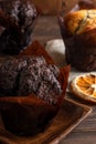 Muffins on wooden plate with dryed oranges, apples and cinnamon