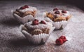 Muffins on a wooden table covered with sugar