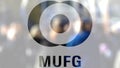 MUFG logo on a glass against blurred crowd on the steet. Editorial 3D rendering