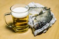 Mug with beer and dried fish at the newspaper Royalty Free Stock Photo